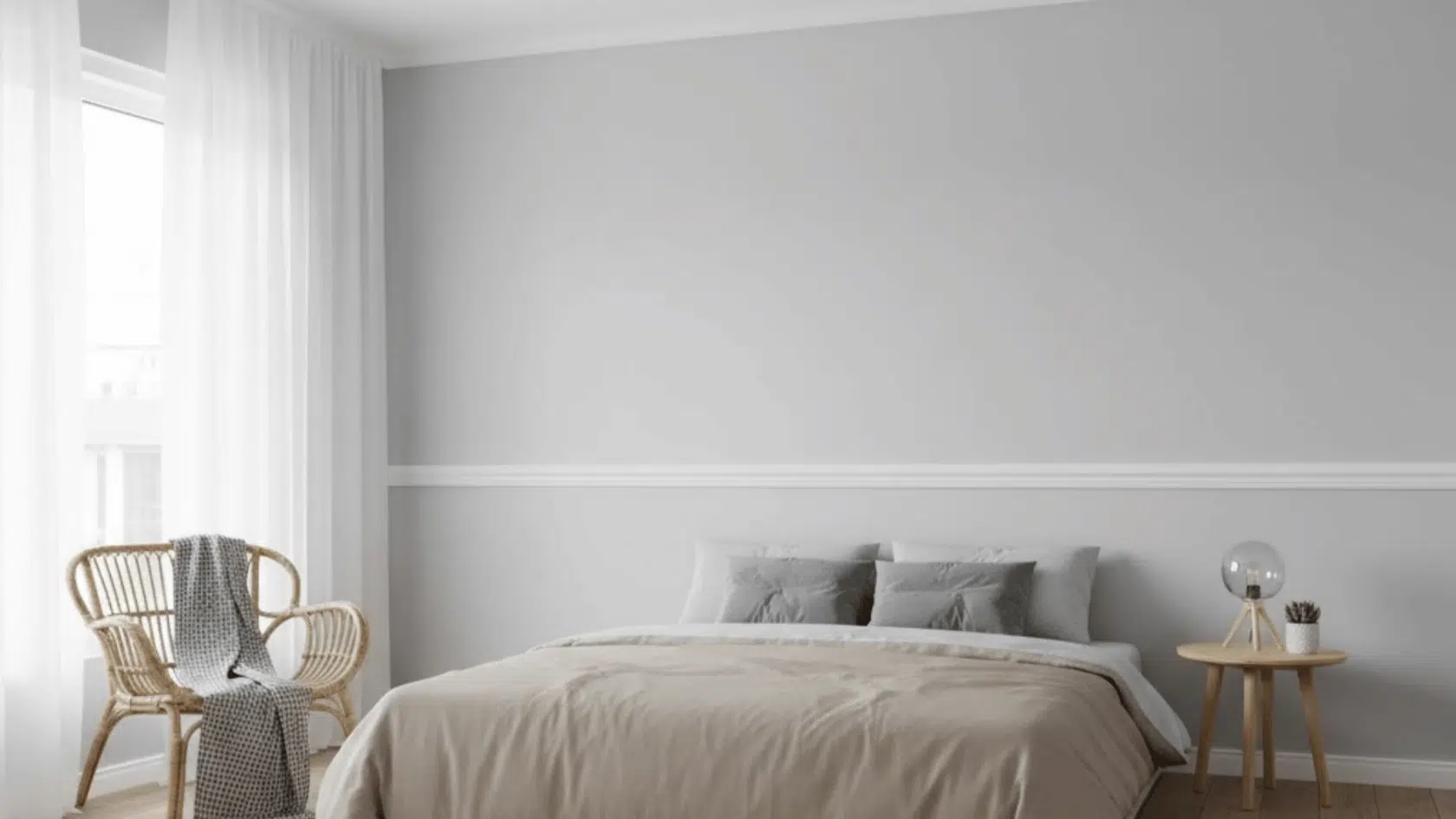 calm bedroom with a classic white wooden chair rail dividing soft gray walls