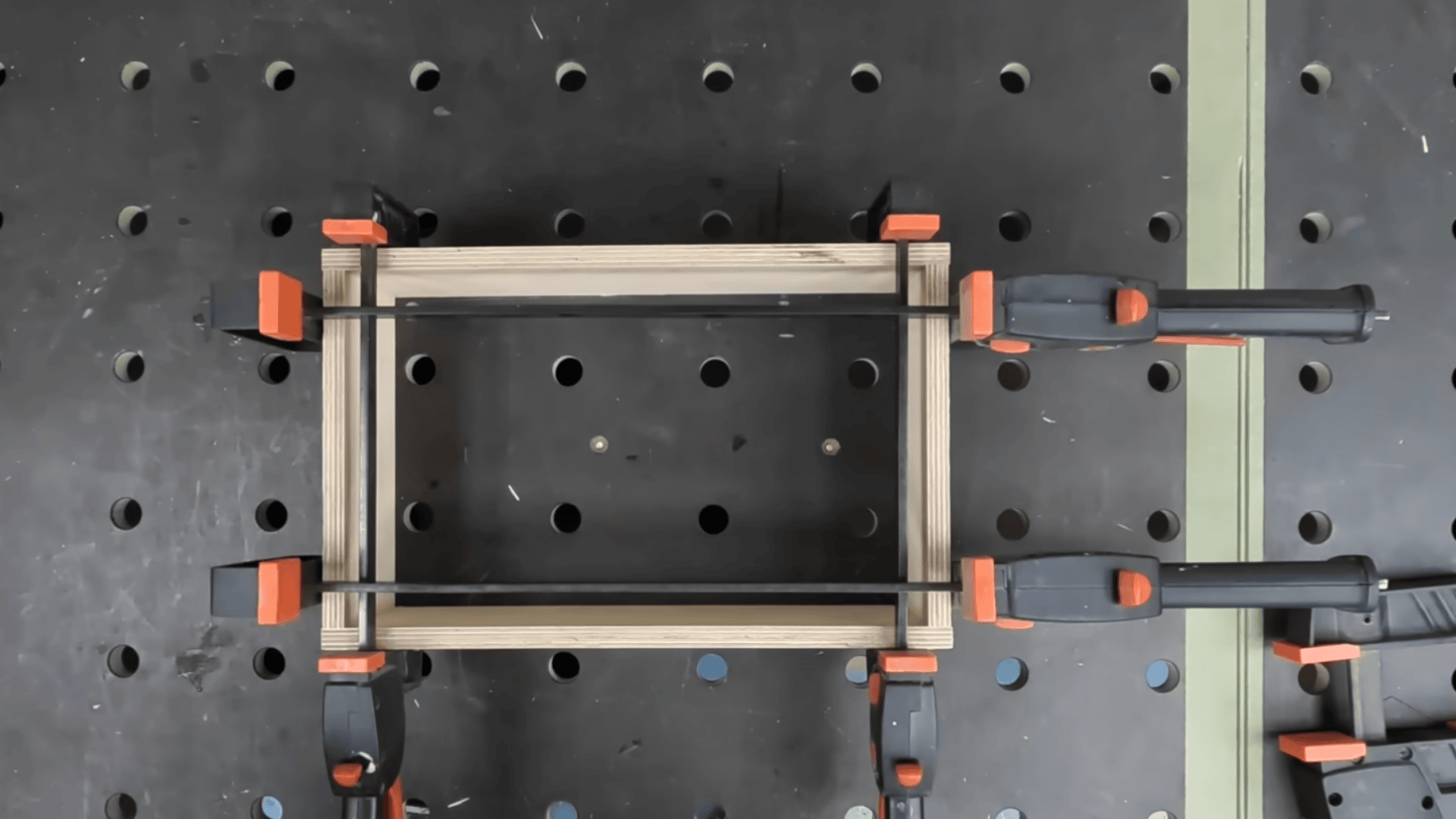 clamped box panels with interlocking finger joints during table saw cutting and assembly.