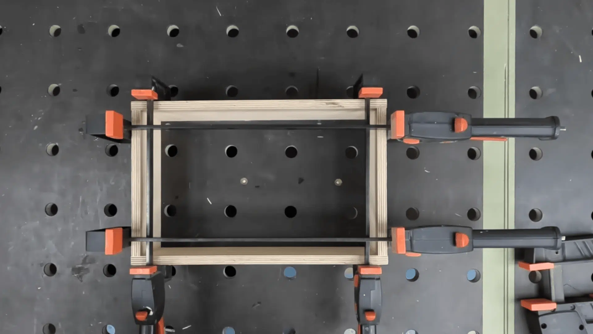 clamped box panels with interlocking finger joints during table saw cutting and assembly.