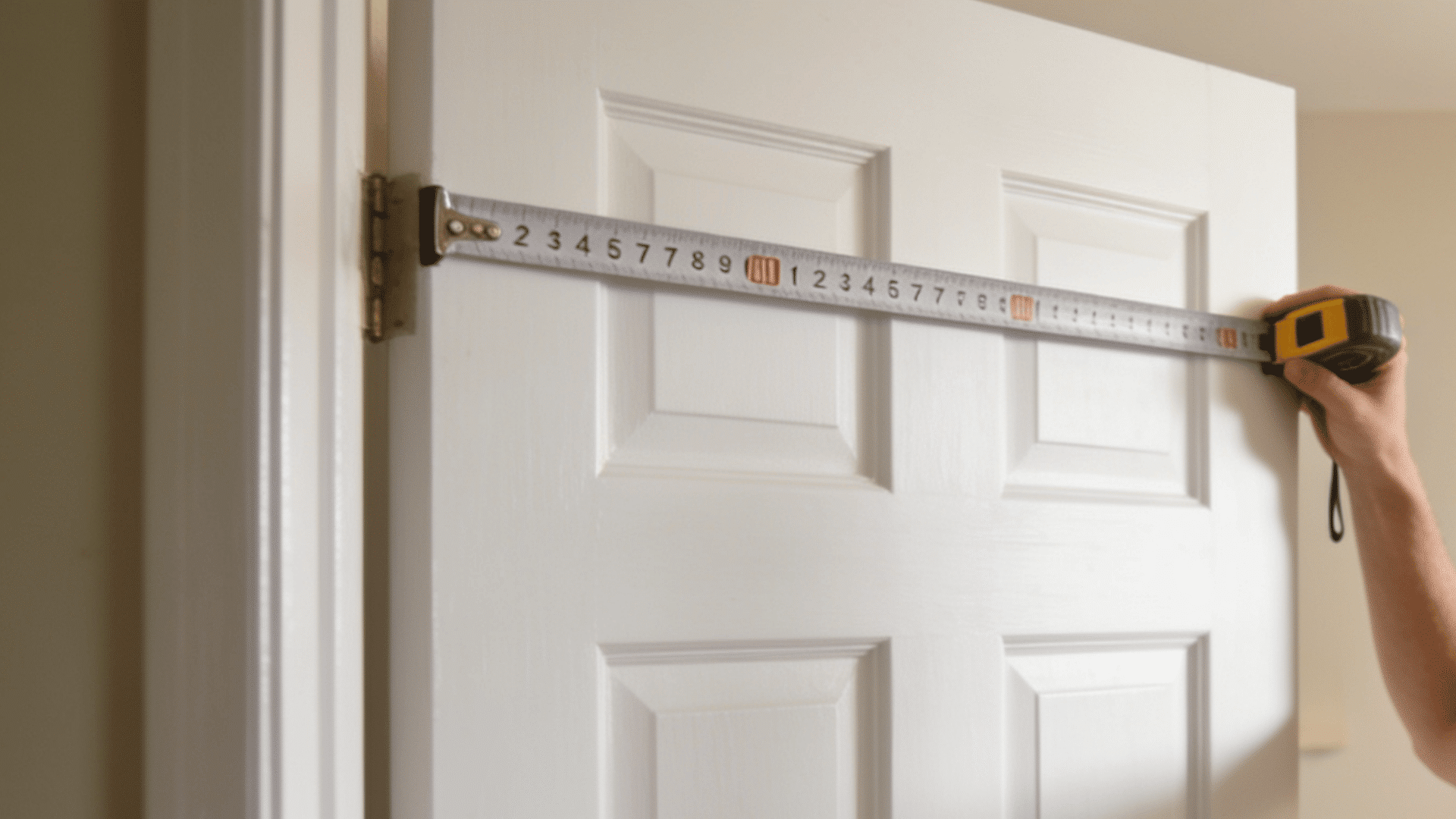 Tape measure stretched across a white bedroom door