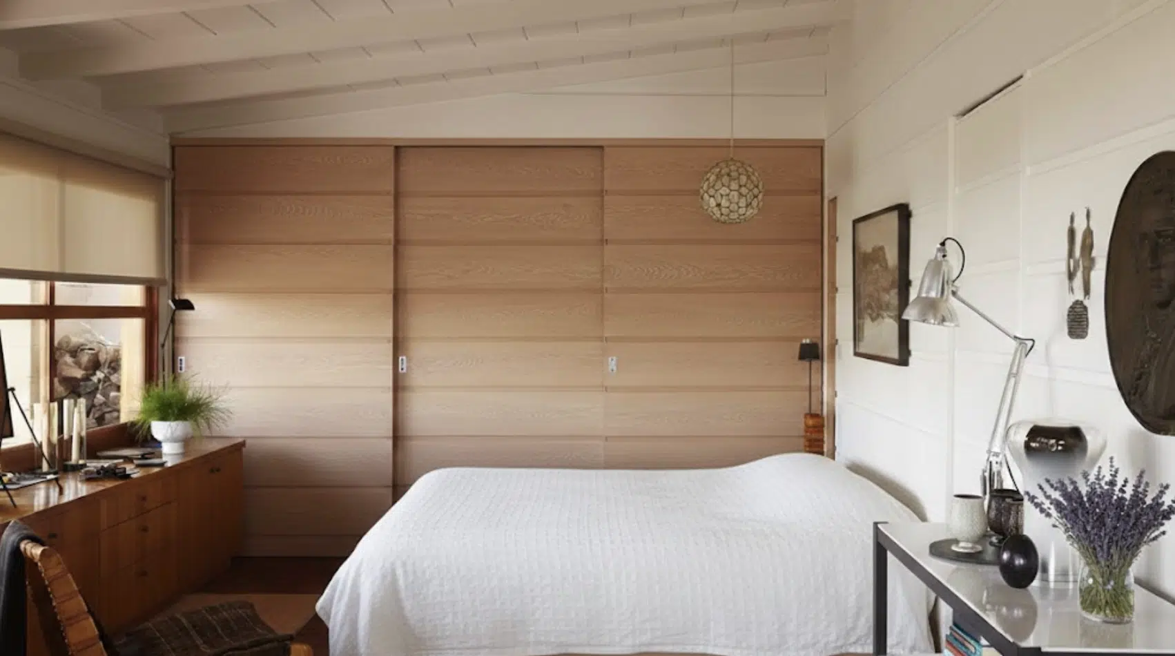 bedroom with built-in wood storage, clean lines, and minimal furniture for a clutter-free layout.