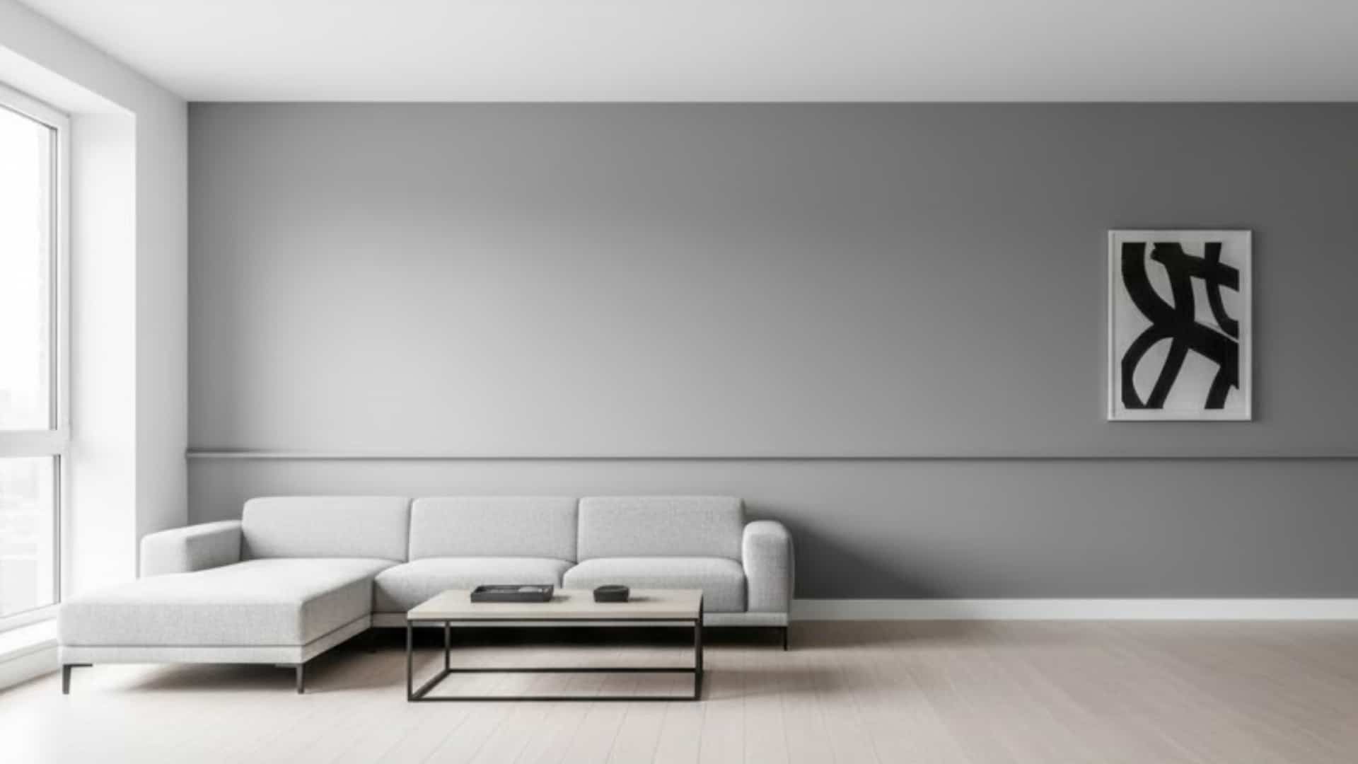 minimalist living room with a white sectional sofa and simple chair rail across a dark gray wall