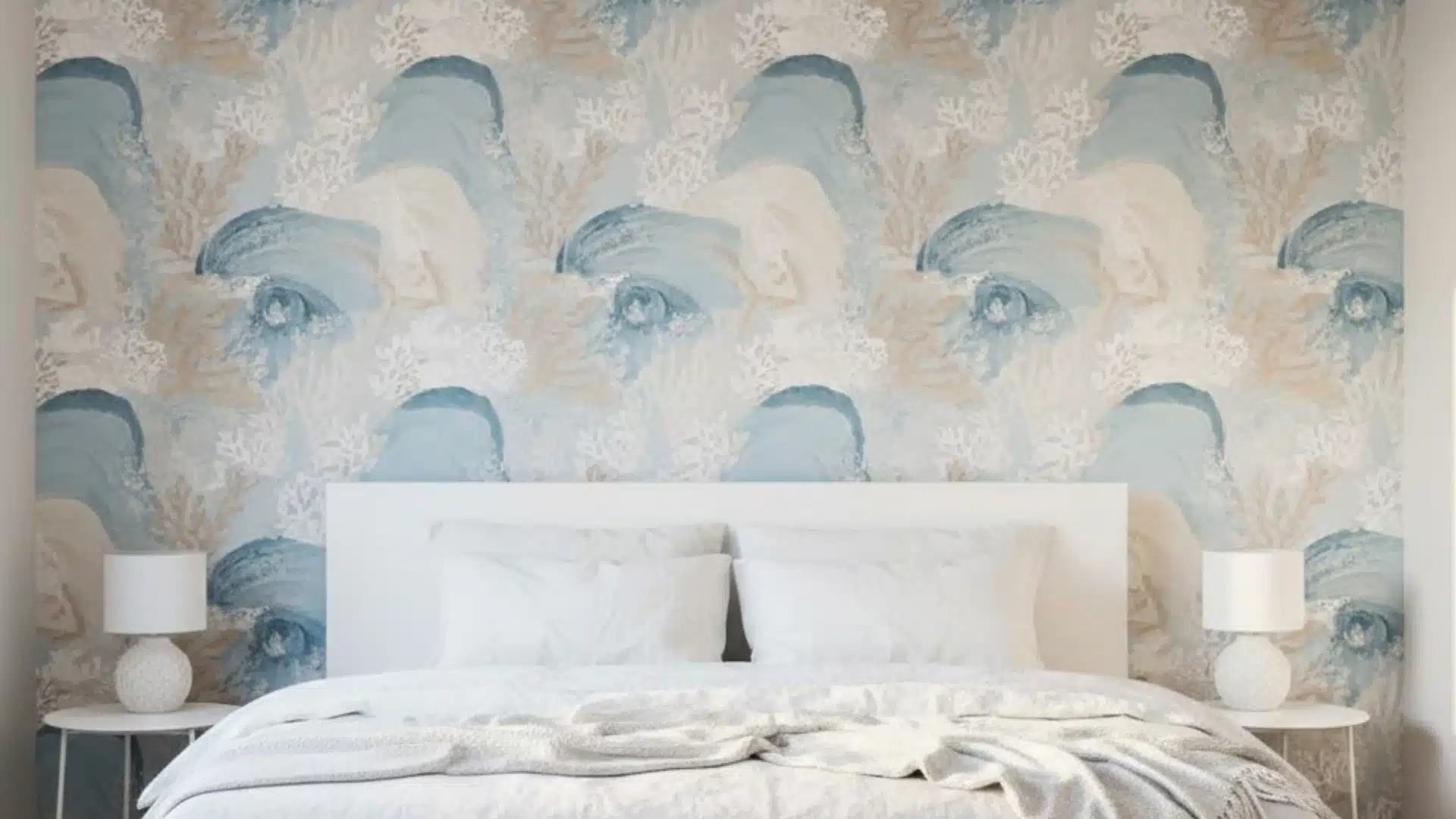 bedroom with pale ocean-themed wallpaper featuring soft blue wave patterns