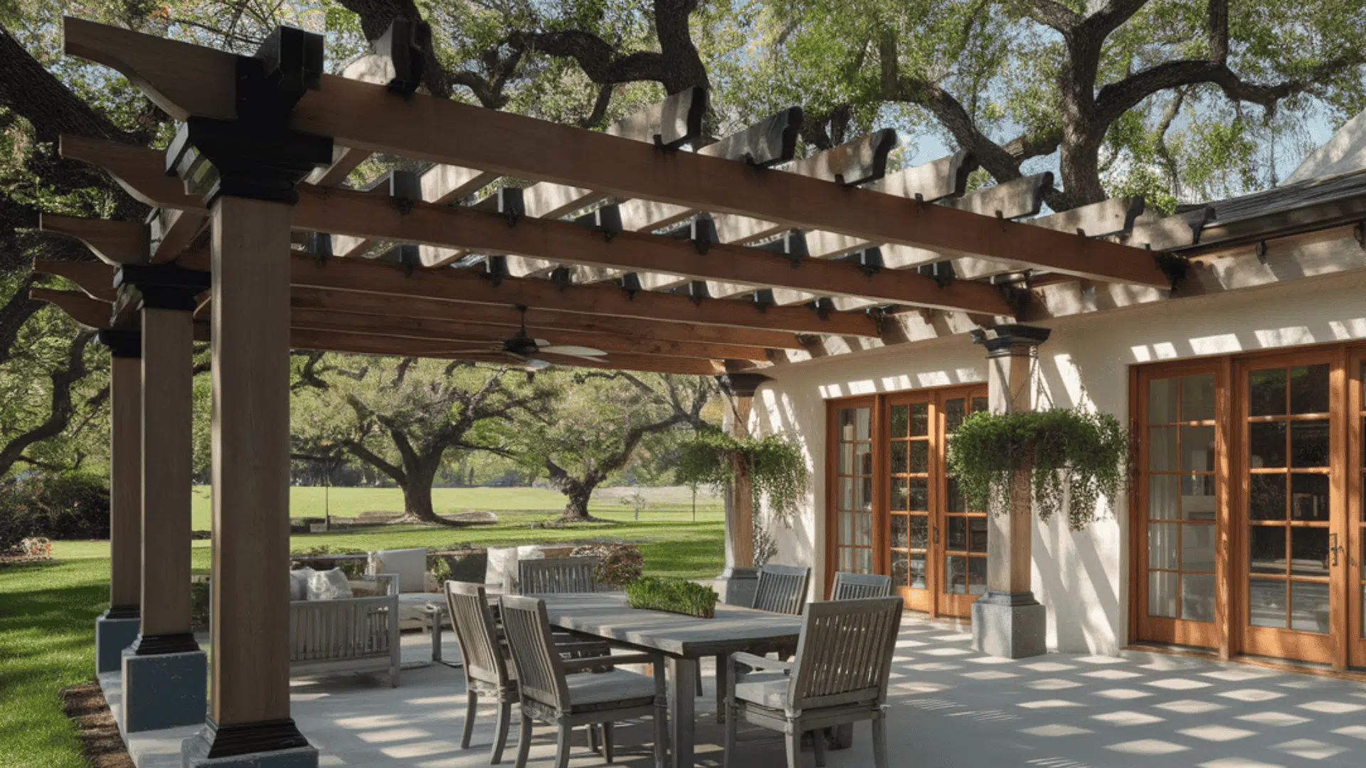 traditional open-slat pergola with timber beams shades an outdoor dining patio beside the home.