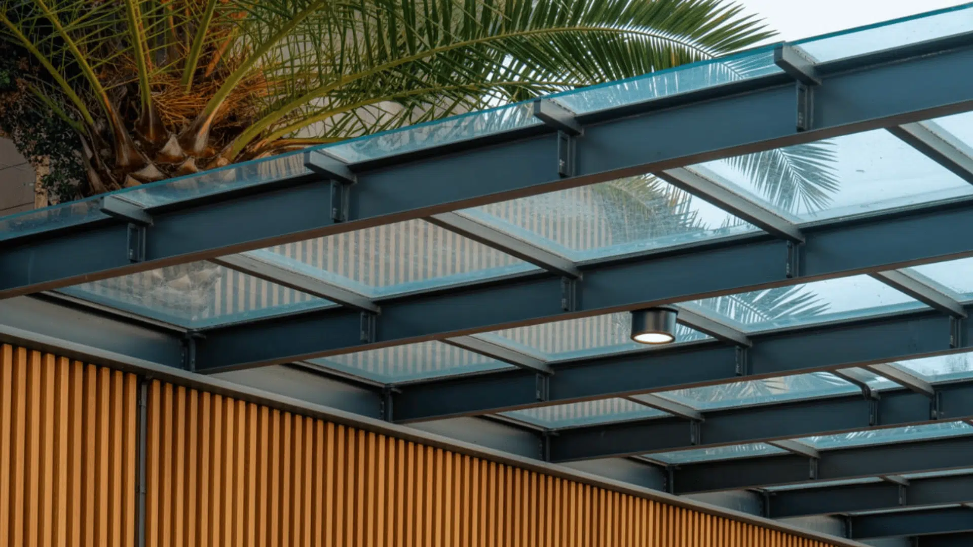 transparent polycarbonate patio roof provides rain protection while letting natural light pass through.