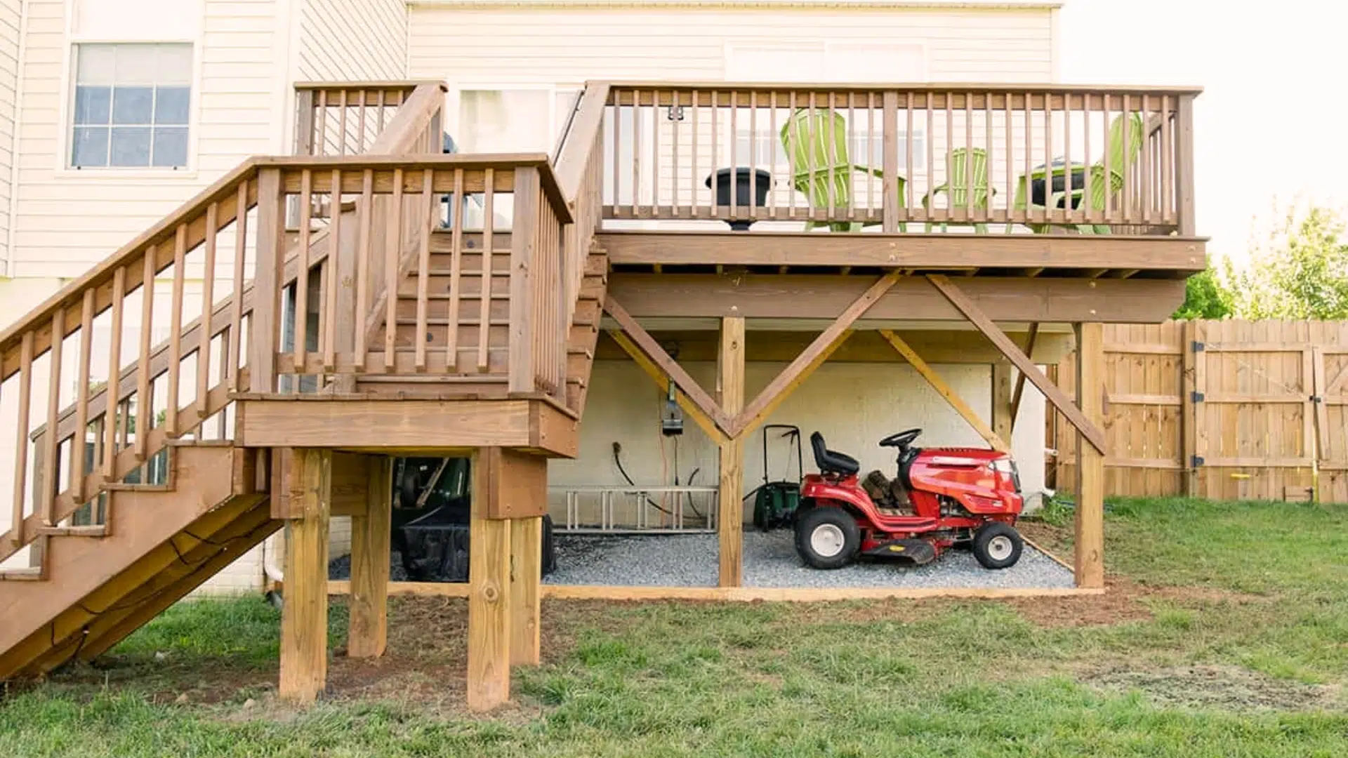 raised wooden deck with open under-deck storage for lawn equipment and outdoor supplies.