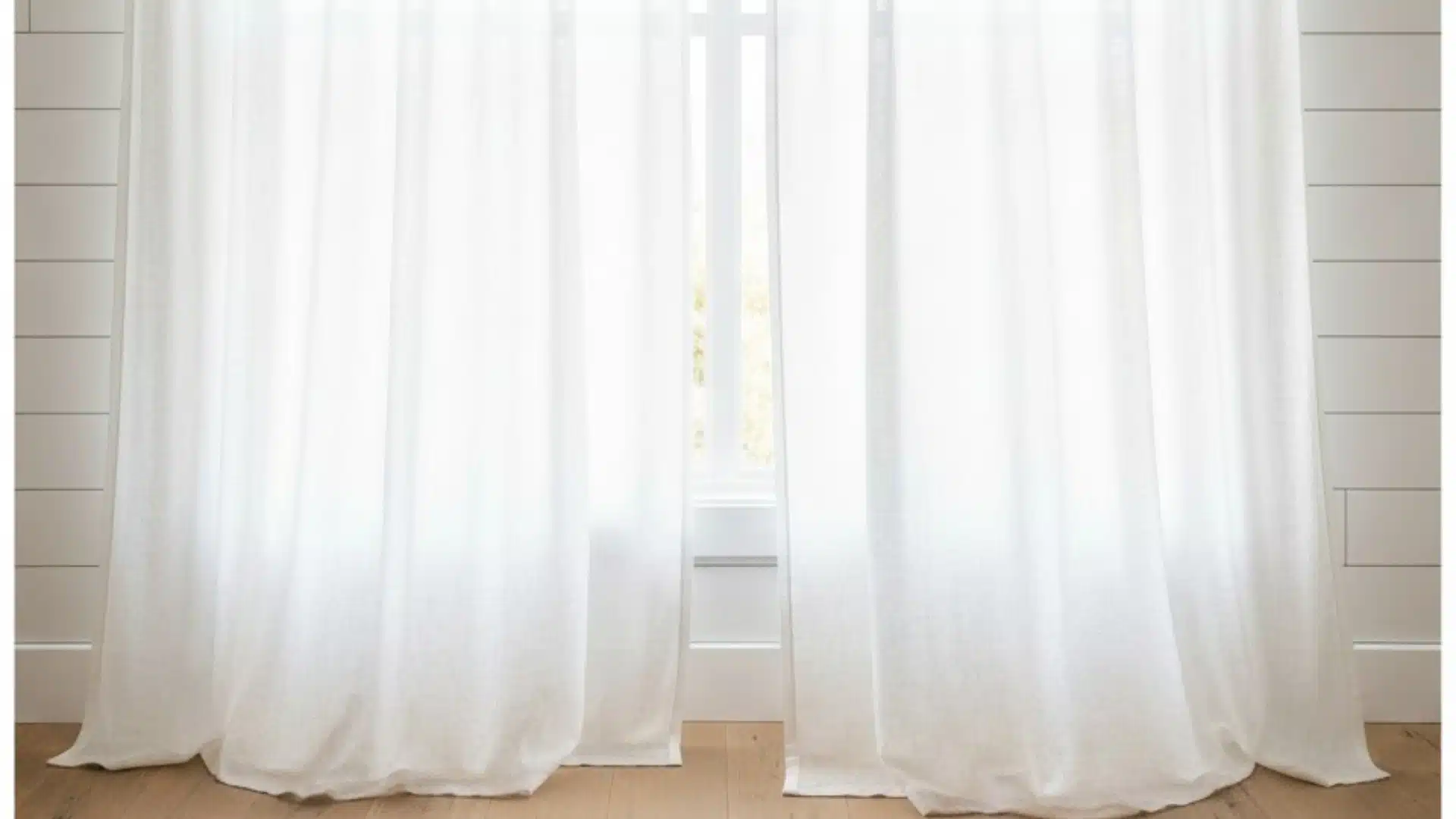 floor-length sheer white curtains filtering sunlight into a bright room