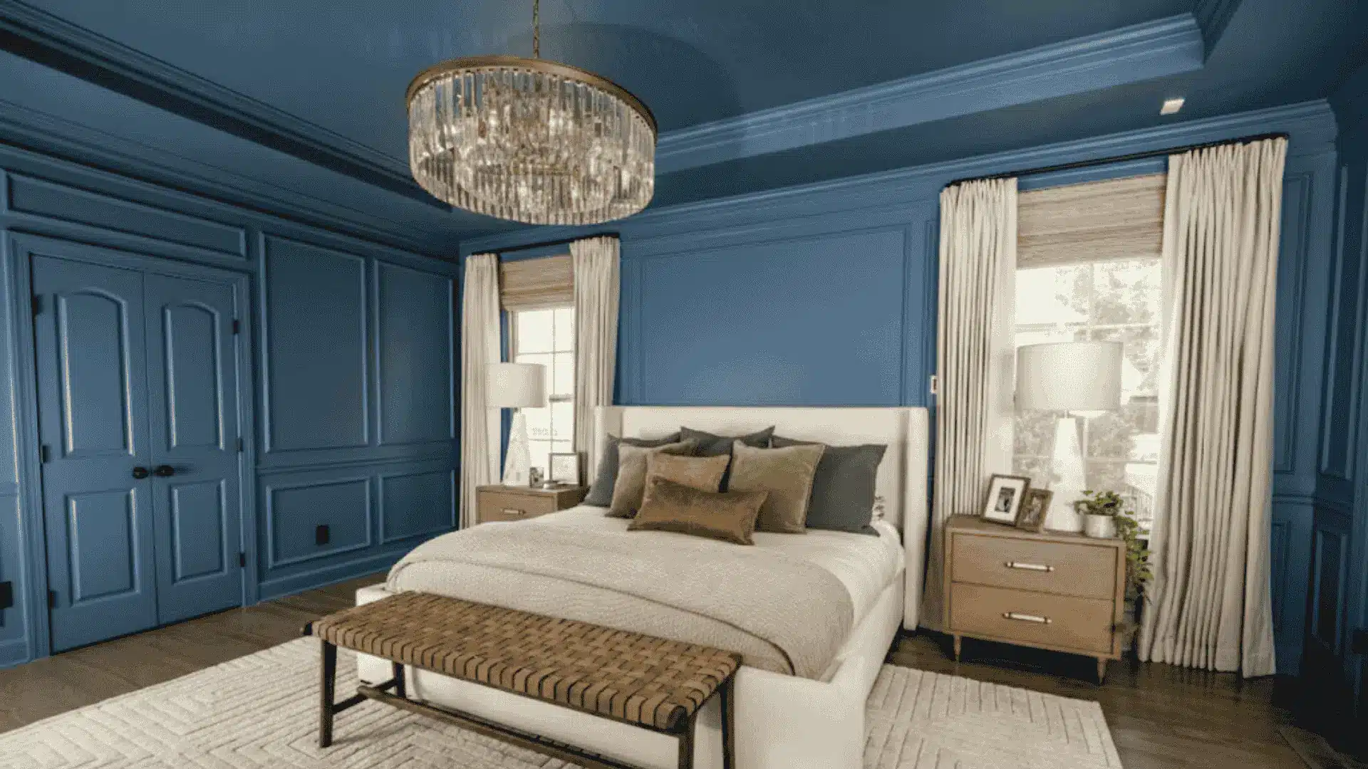 Sophisticated interior design featuring blue walls, a white bed, and a crystal chandelier in a bright bedroom