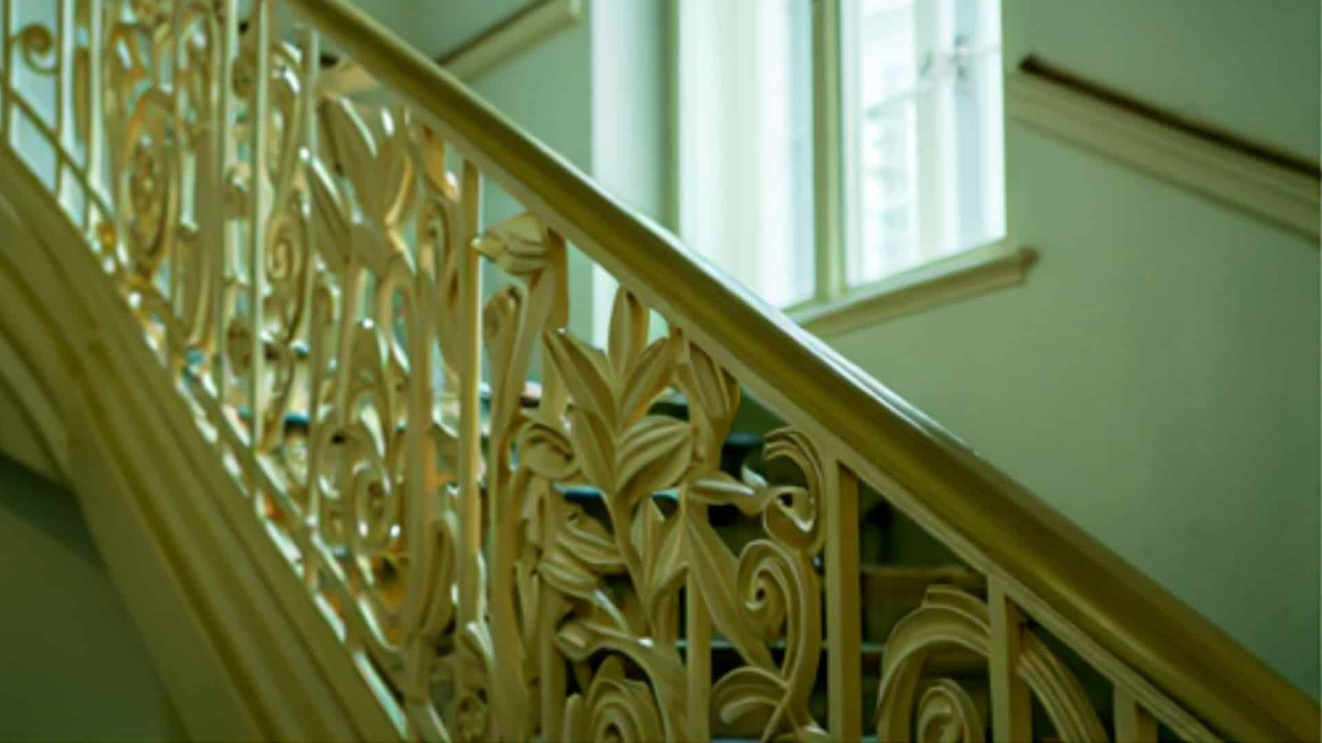 close-up of ornate victorian chair rail molding with carved floral details