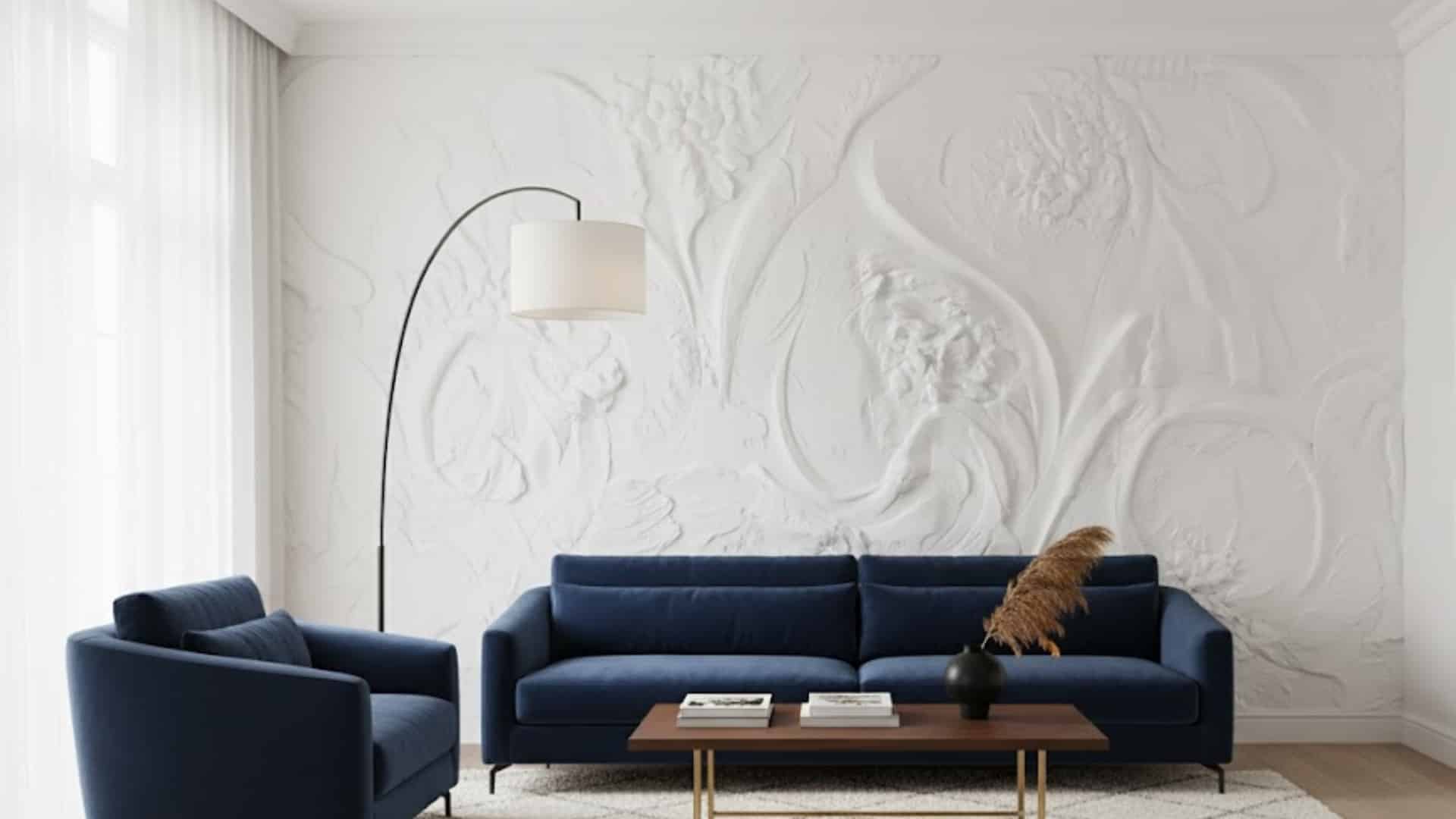 elegant living room with navy seating and sculpted white bas relief feature wall