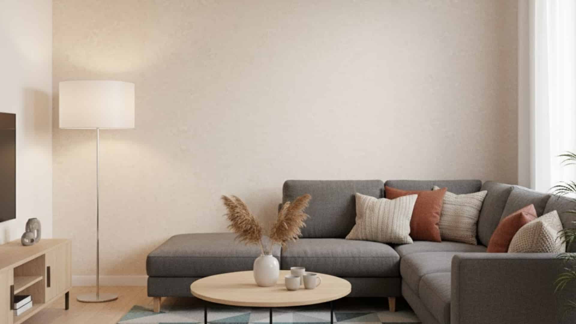 cozy living room with gray sectional sofa and warm beige medium textured wall