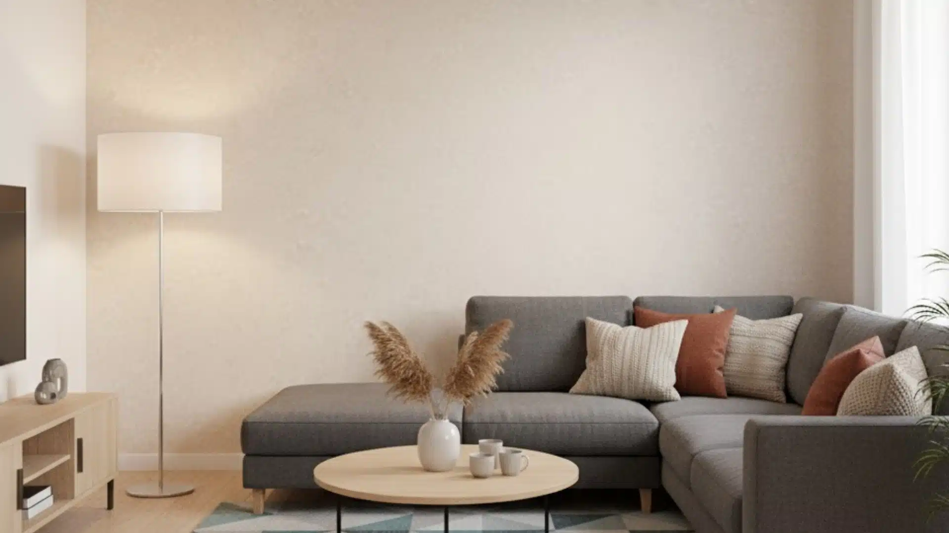 cozy living room with gray sectional sofa and warm beige medium textured wall