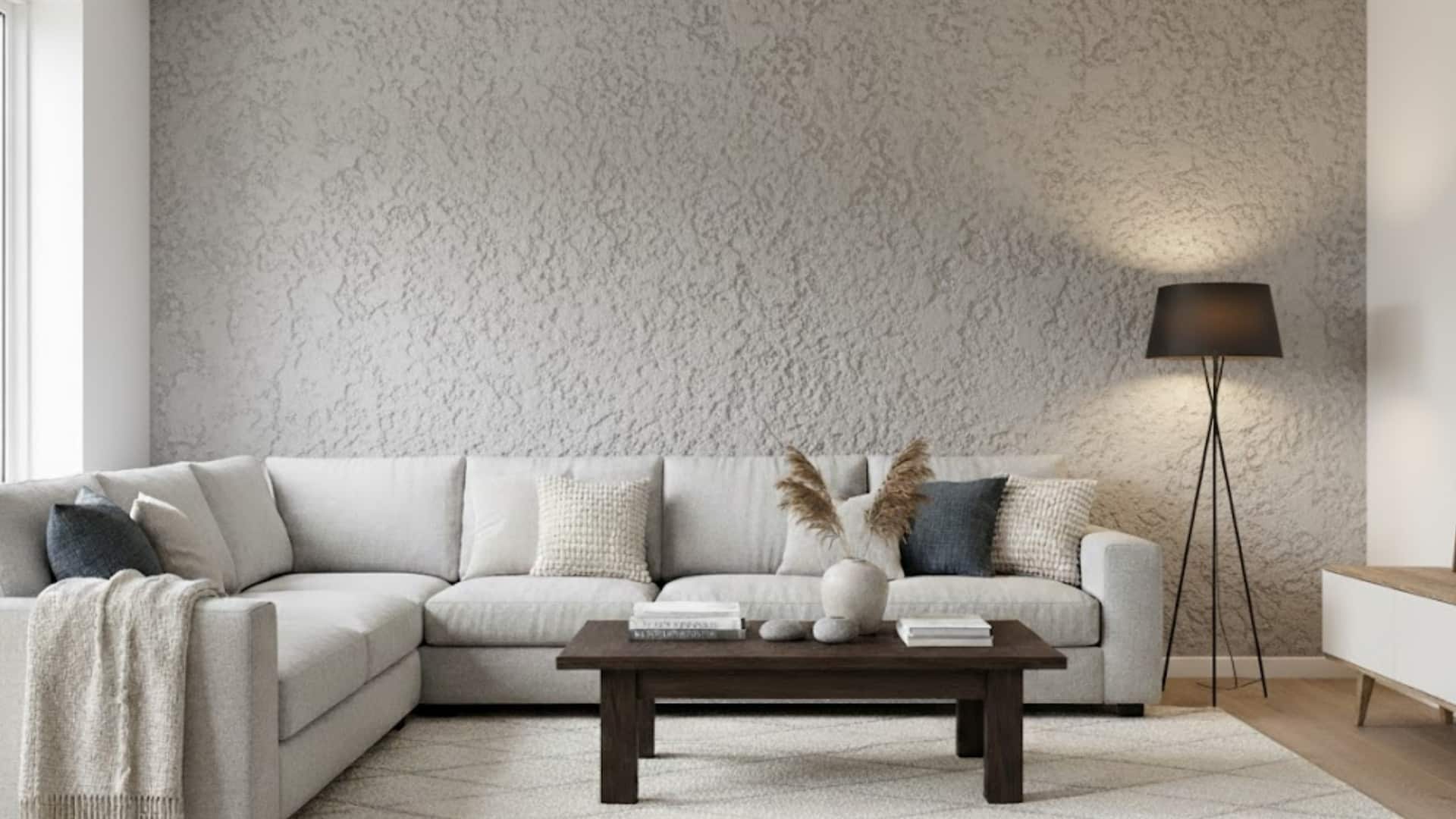 modern living room with white sectional sofa and rough spray sand textured gray wall