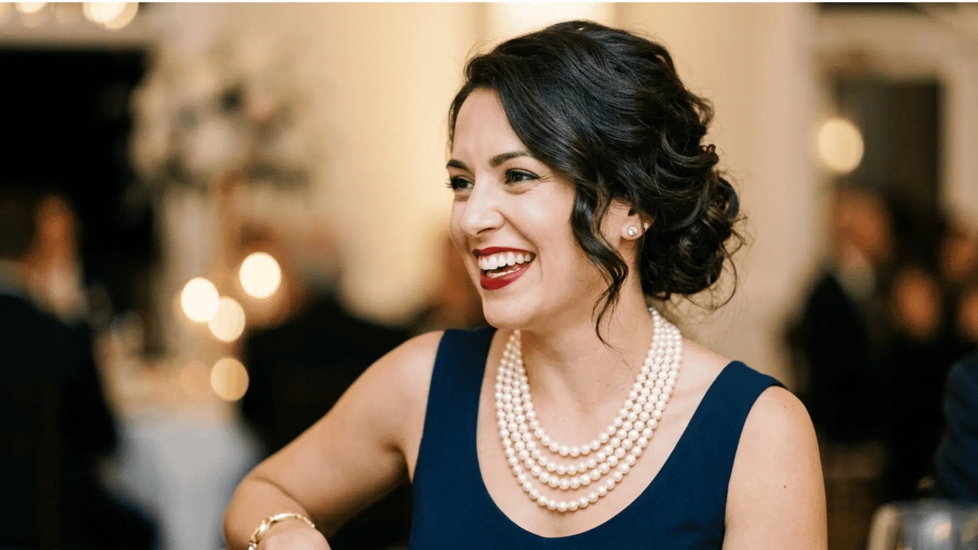 Woman wearing pearl jewelry with a classic vintage evening look.