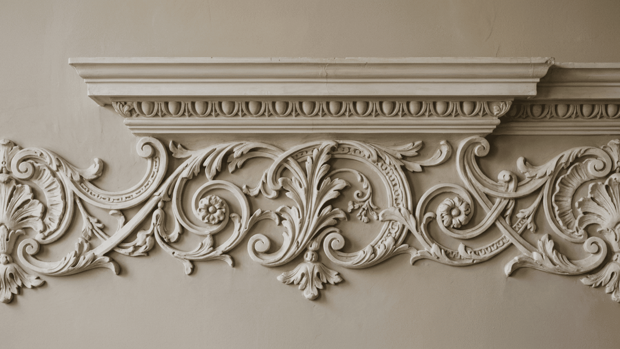 Detailed European architectural molding with intricate stone carvings, floral patterns, and decorative classical craftsmanship.