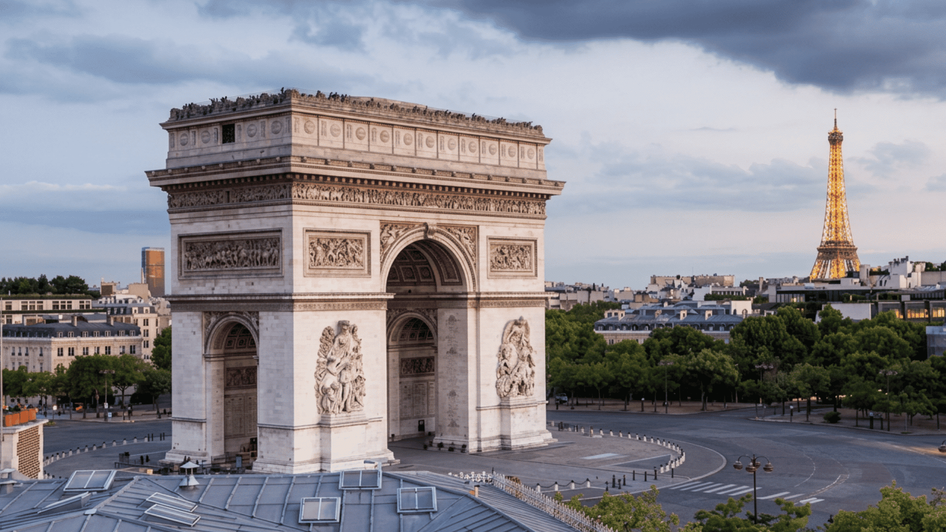 Arc de Triomphe with carved stone details and Eiffel Tower in the distance
